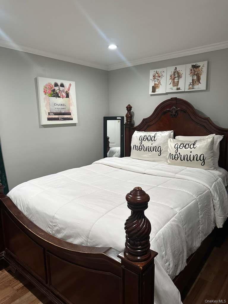 2 Ritter Avenue Amityville, NY 11701 - Photo 15 of 26 a bedroom with a bed and a painting on the wall