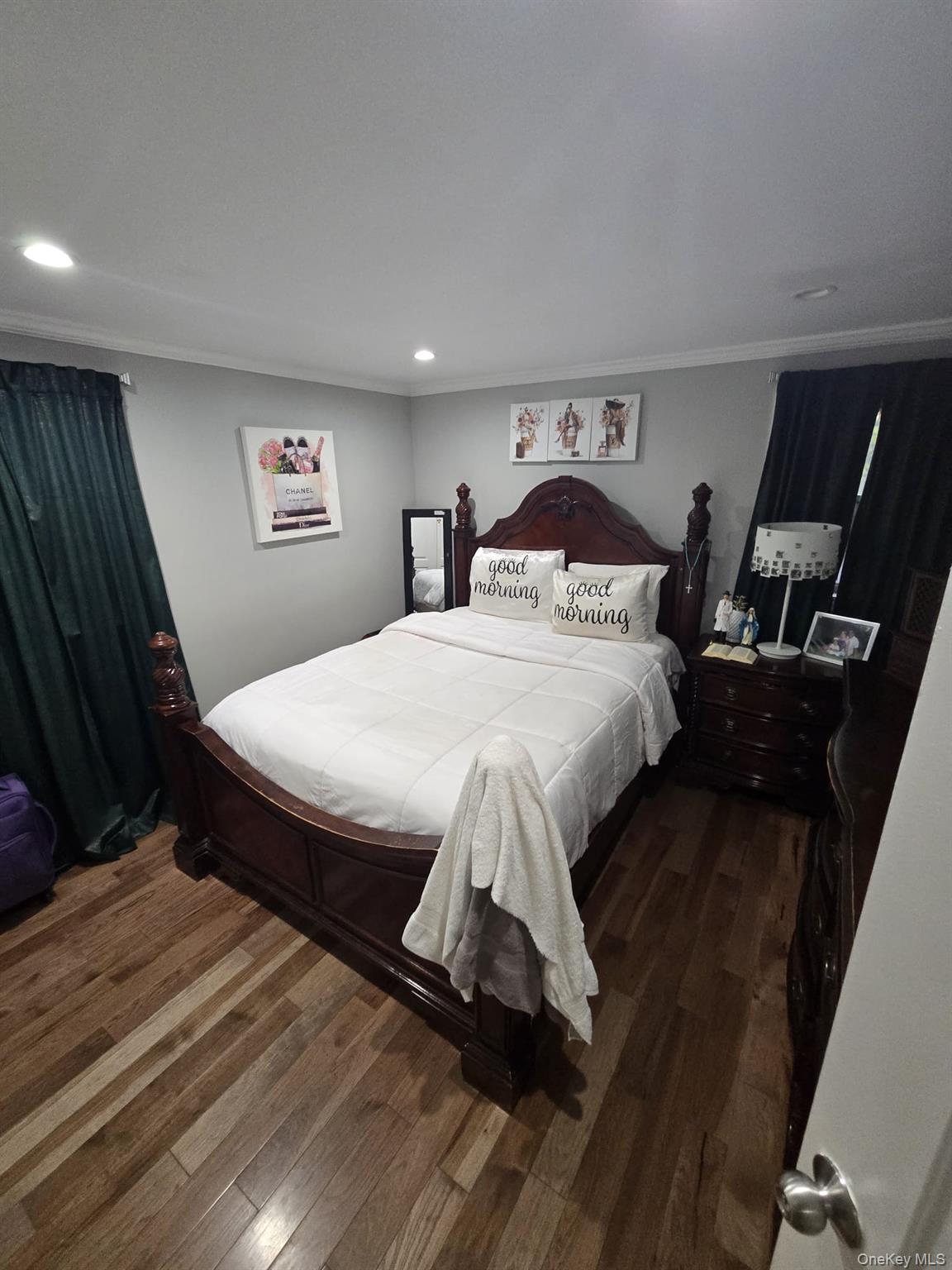 2 Ritter Avenue Amityville, NY 11701 - Photo 16 of 26 a bedroom with a bed and wooden floor