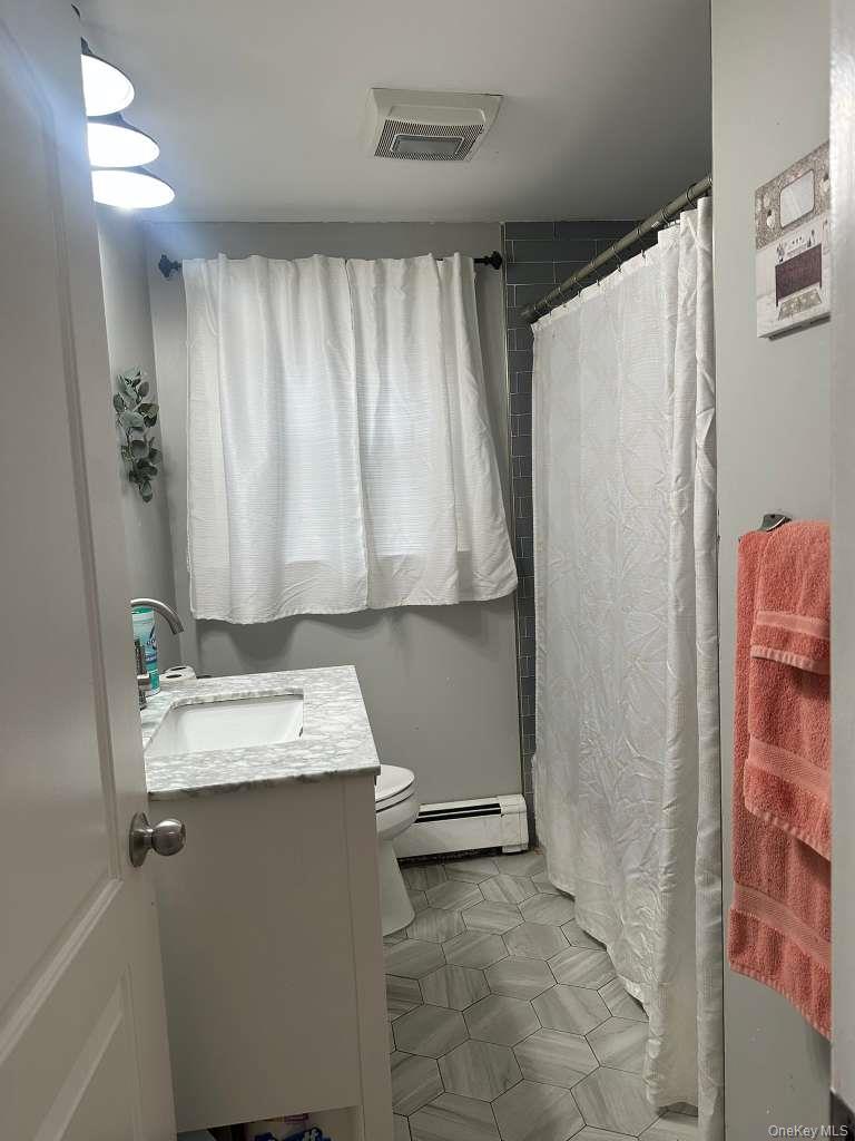 2 Ritter Avenue Amityville, NY 11701 - Photo 20 of 26 a bathroom with a sink and a mirror