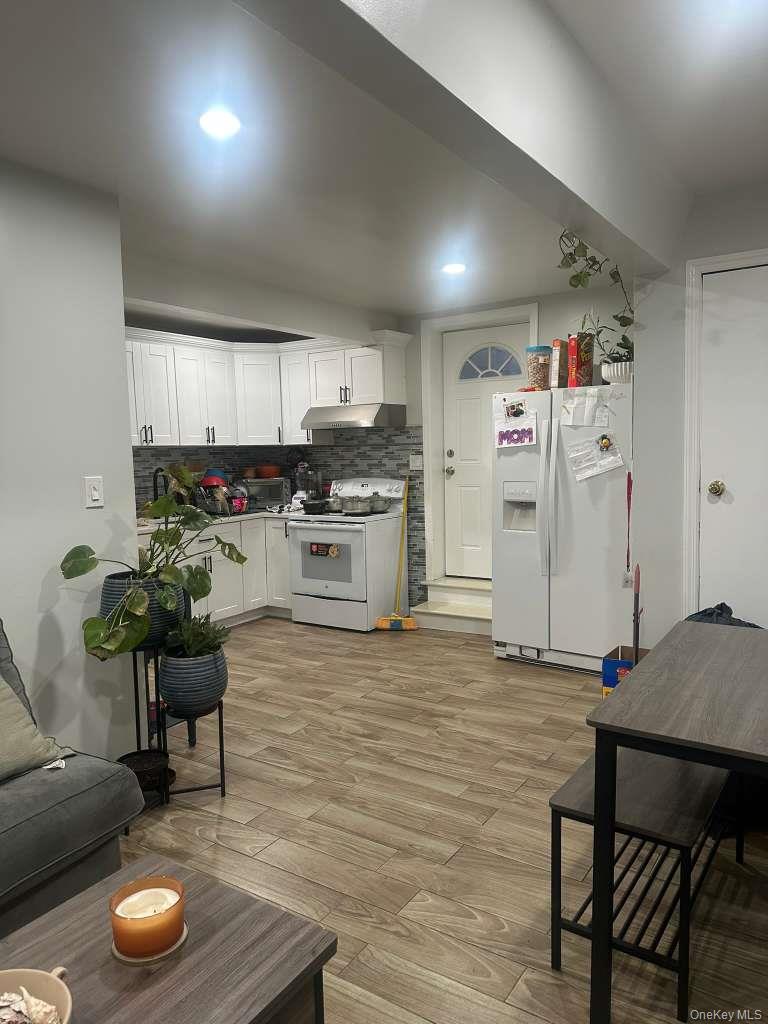 2 Ritter Avenue Amityville, NY 11701 - Photo 25 of 26 a kitchen with stainless steel appliances kitchen island granite countertop a stove a refrigerator and a wooden cabinets