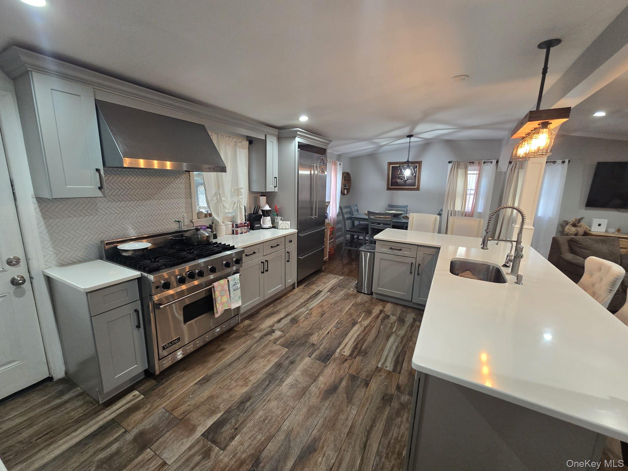 2 Ritter Avenue Amityville, NY 11701 - Photo 6 of 26 a kitchen with sink a stove and refrigerator