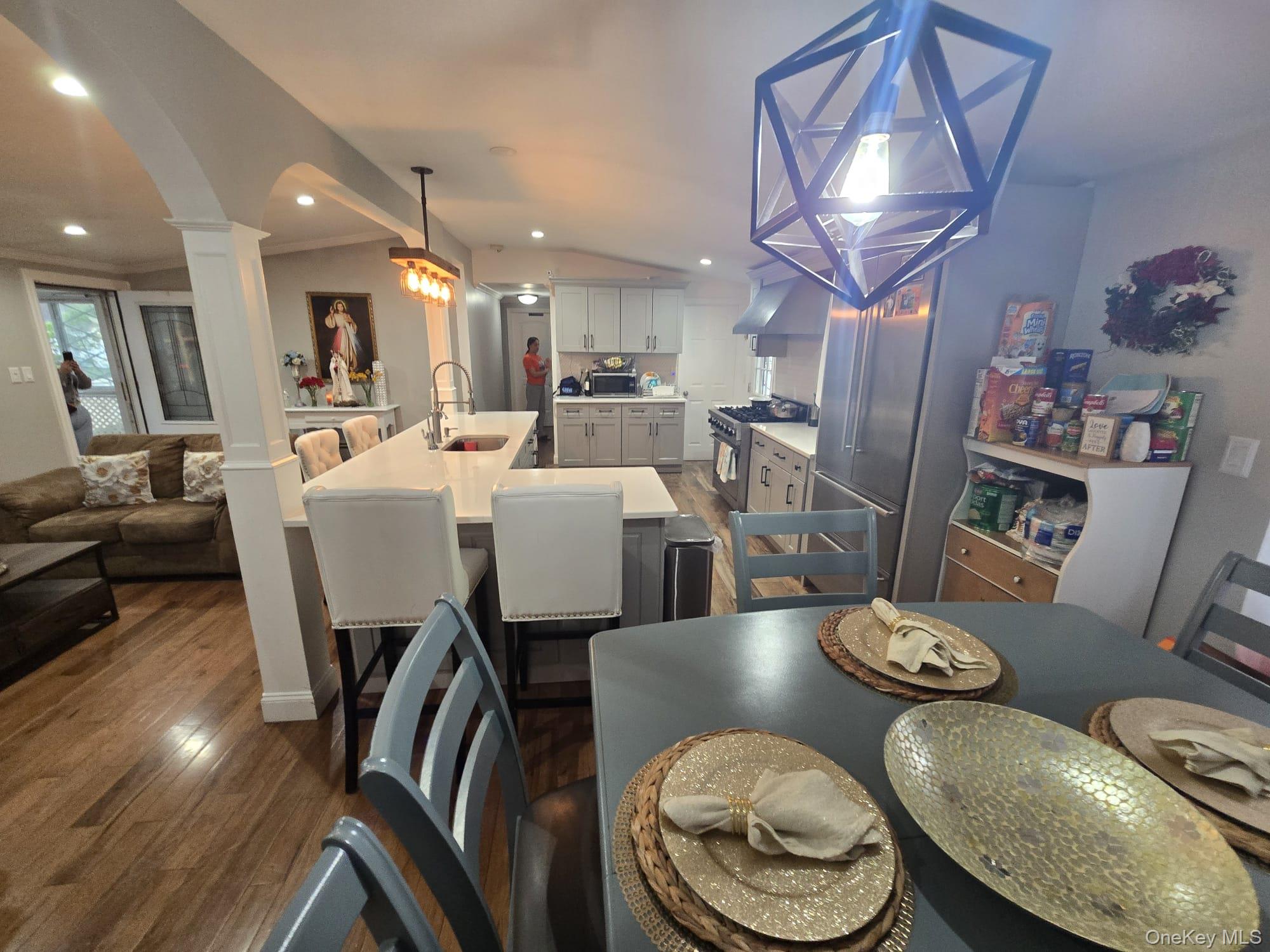 2 Ritter Avenue Amityville, NY 11701 - Photo 7 of 26 a view of a dining room with furniture wooden floor and chandelier