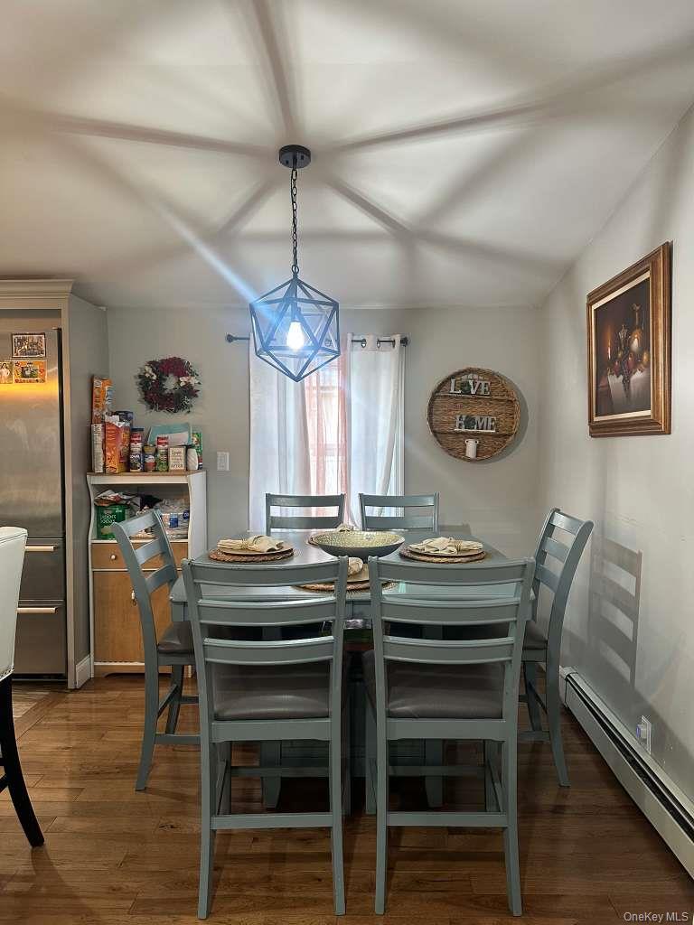 2 Ritter Avenue Amityville, NY 11701 - Photo 8 of 26 a view of a dining room with furniture a chandelier and wooden floor