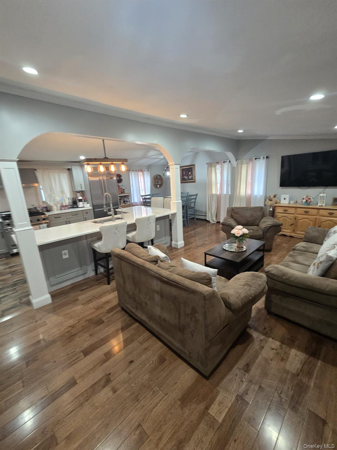 2 Ritter Avenue Amityville, NY 11701 - Photo 9 of 26 a living room with stainless steel appliances kitchen island granite countertop a couch and a view of kitchen