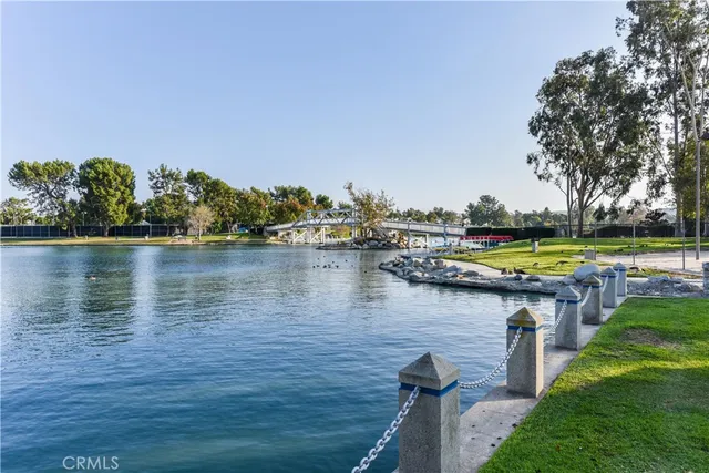 a small pool with a bench and lake view