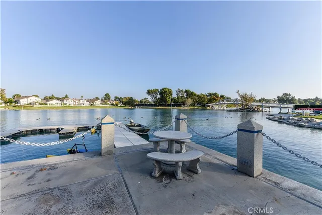 a wooden floor with outdoor seating and water view