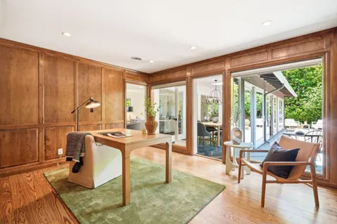 a living room with furniture a large window