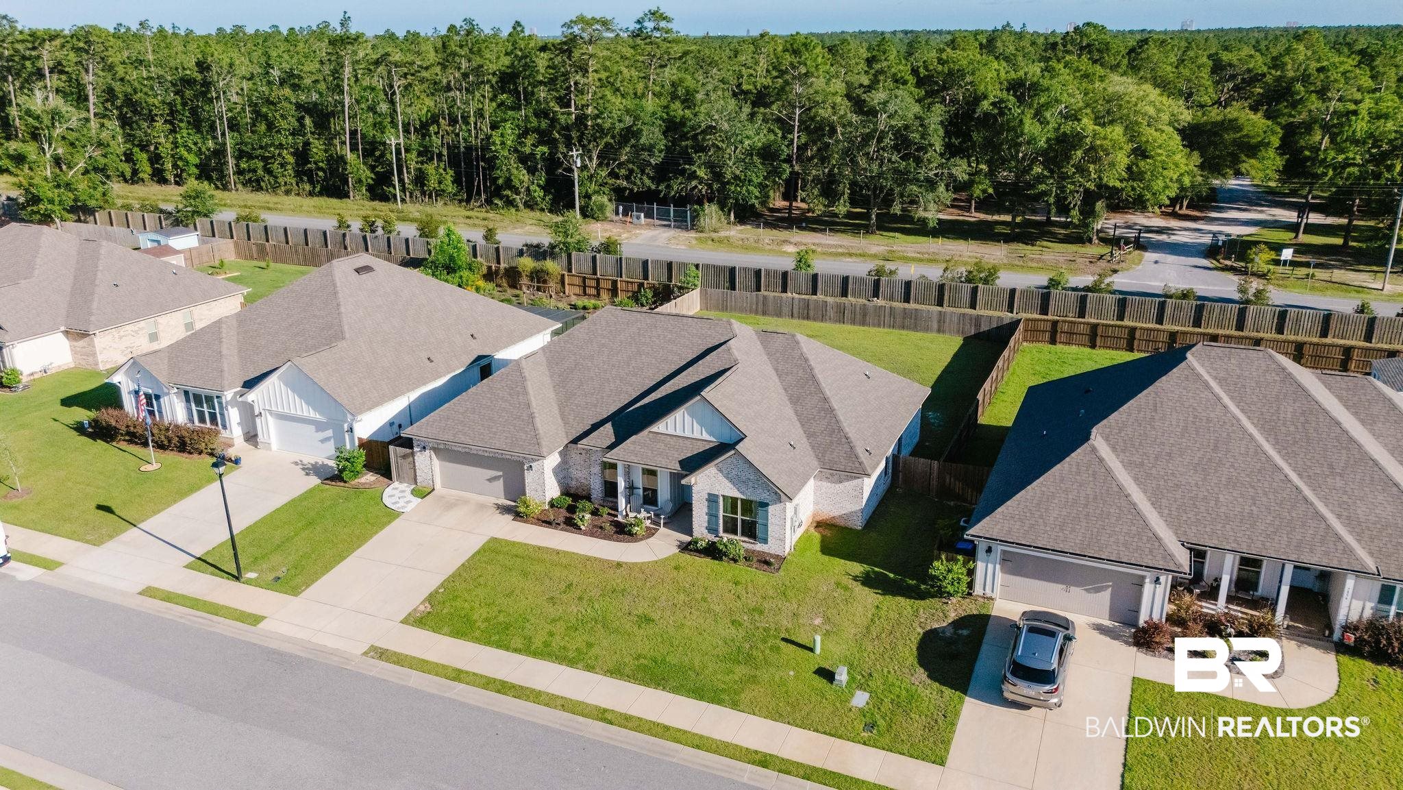 7872 Calverton Street Foley, AL 36535 - Photo 69 of 76 Contemporary residence featuring a light-colored exterior, two-car garage, and landscaped front yard