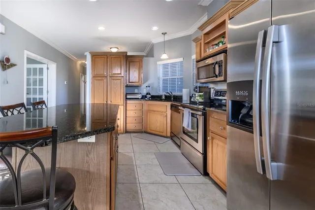 a kitchen with stainless steel appliances granite countertop a sink and a stove