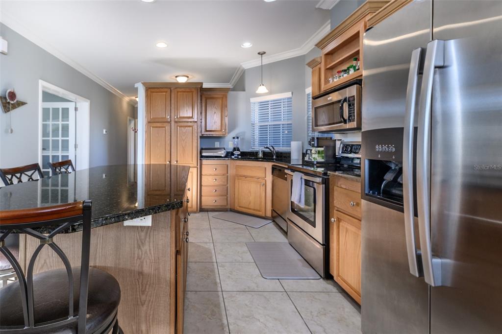 2 Emden Circle Punta Gorda, FL 33950 - Photo 13 of 60 a kitchen with stainless steel appliances granite countertop a refrigerator a stove and a sink