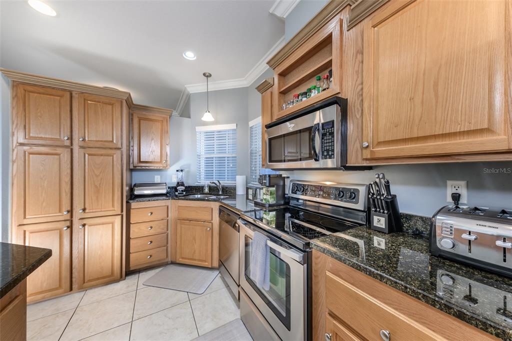 2 Emden Circle Punta Gorda, FL 33950 - Photo 15 of 60 a kitchen with stainless steel appliances granite countertop a refrigerator and a stove top oven