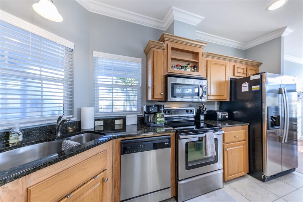 2 Emden Circle Punta Gorda, FL 33950 - Photo 16 of 60 a kitchen with stainless steel appliances granite countertop a sink and a stove