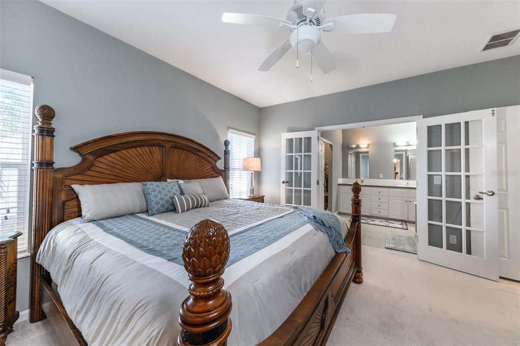 2 Emden Circle Punta Gorda, FL 33950 - Photo 40 of 60 a bedroom with a bed and a chandelier