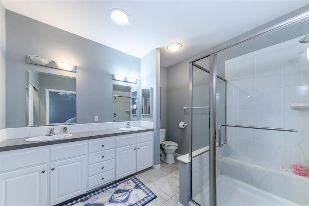 2 Emden Circle Punta Gorda, FL 33950 - Photo 43 of 60 a bathroom with a double vanity sink toilet mirror bathtub and window