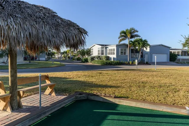 a view of a backyard with potted plants and large trees