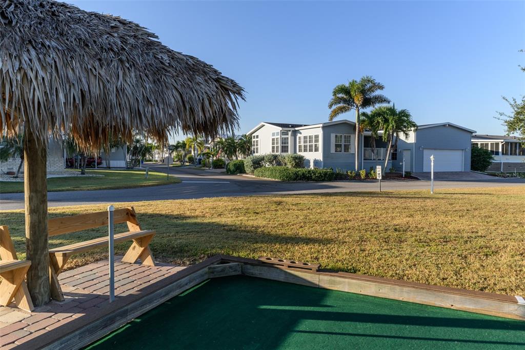 2 Emden Circle Punta Gorda, FL 33950 - Photo 46 of 60 a view of swimming pool with outdoor seating and trees in the background