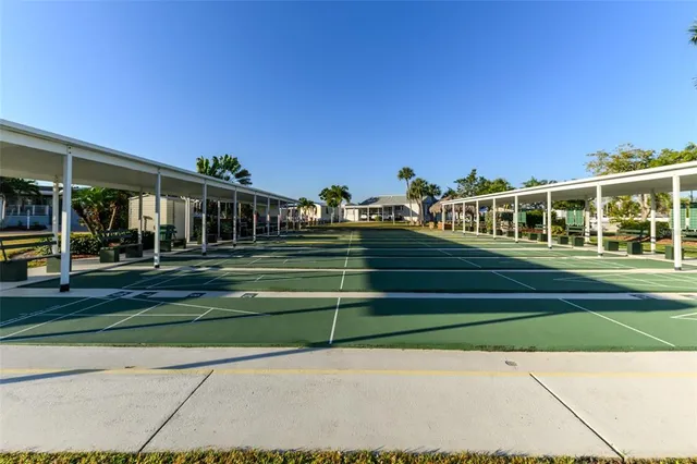 a room with stainless steel appliances lots of wooden furniture