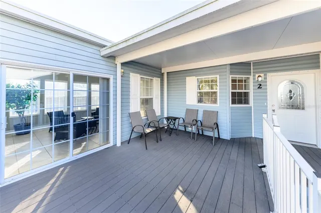 a kitchen with stainless steel appliances granite countertop a stove top oven a sink a dining table and chairs