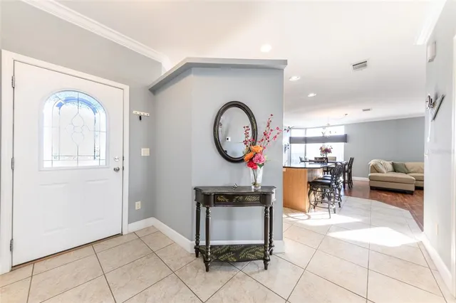 a kitchen with stainless steel appliances kitchen island granite countertop a refrigerator a stove a microwave oven with a dining table and chairs