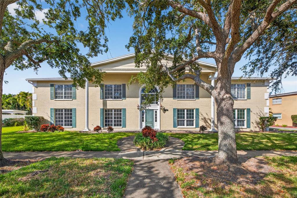 a front view of a house with a garden