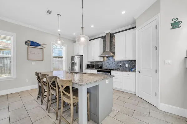 a kitchen with stainless steel appliances granite countertop a sink stove and cabinets