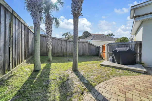 a view of a backyard with swimming pool in the background
