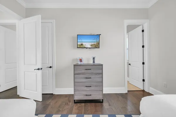 a bedroom with a large bed chandelier and a window