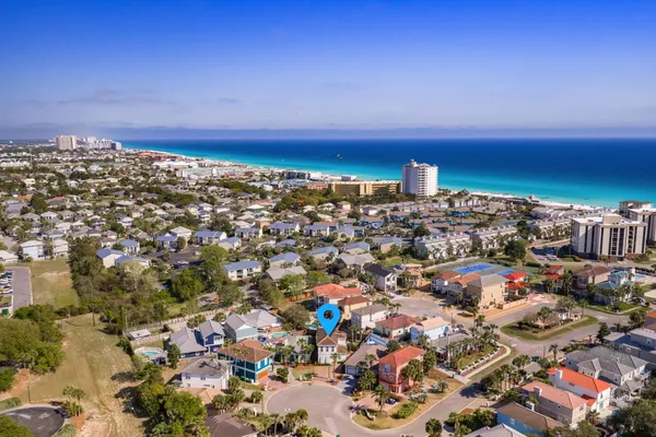 an aerial view of a house with a yard