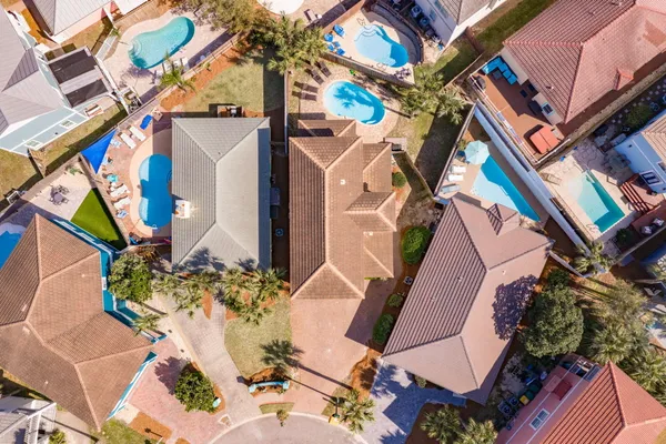an aerial view of a house with a yard and potted plants