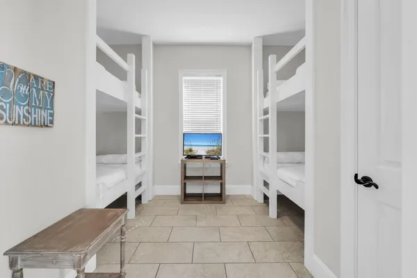 a bathroom with a granite countertop double vanity sink and mirror with shower