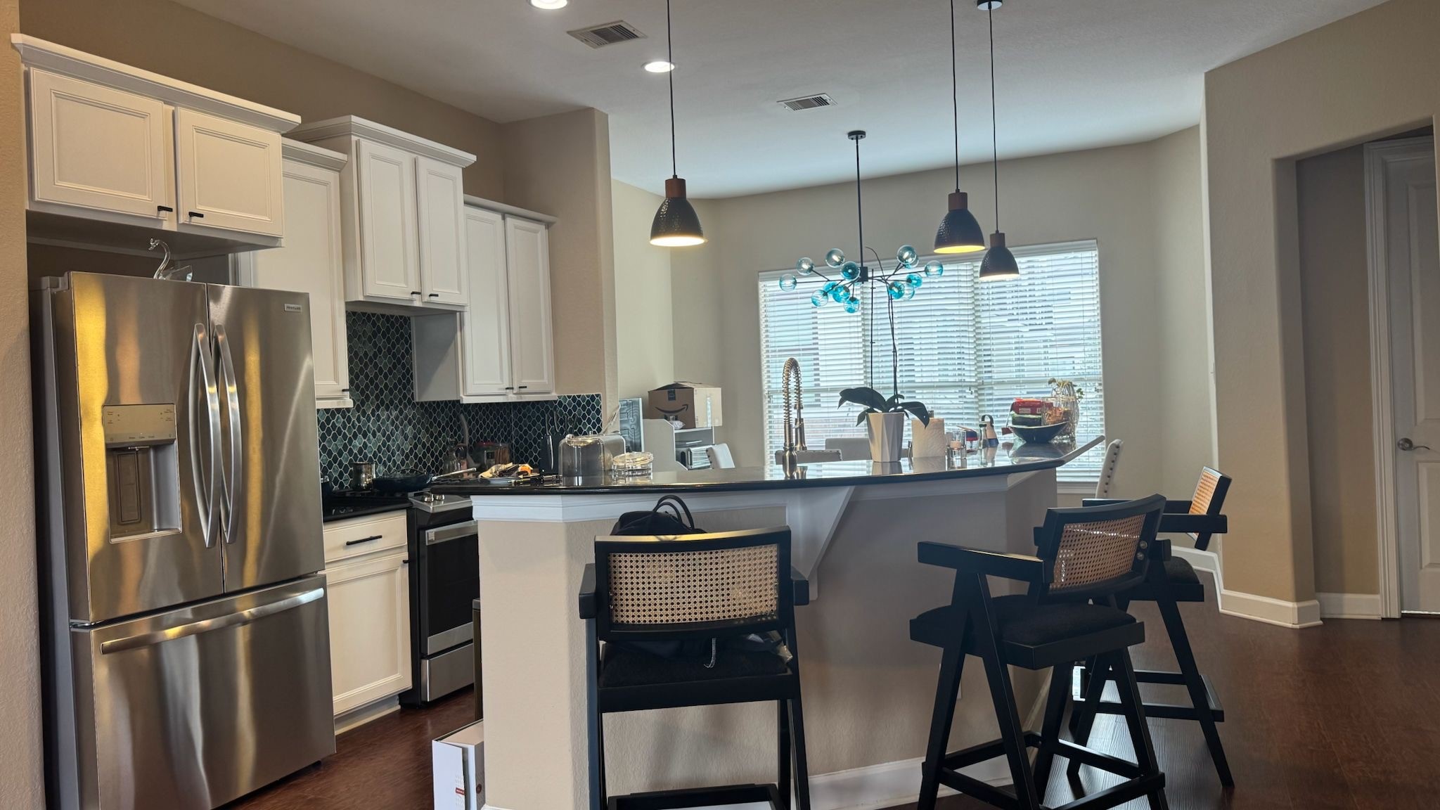 2814 Polk Street Houston, TX 77003 - Photo 5 of 9 a kitchen with stainless steel appliances a dining table chairs refrigerator and sink