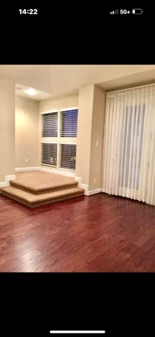 a view of a room with wooden floor