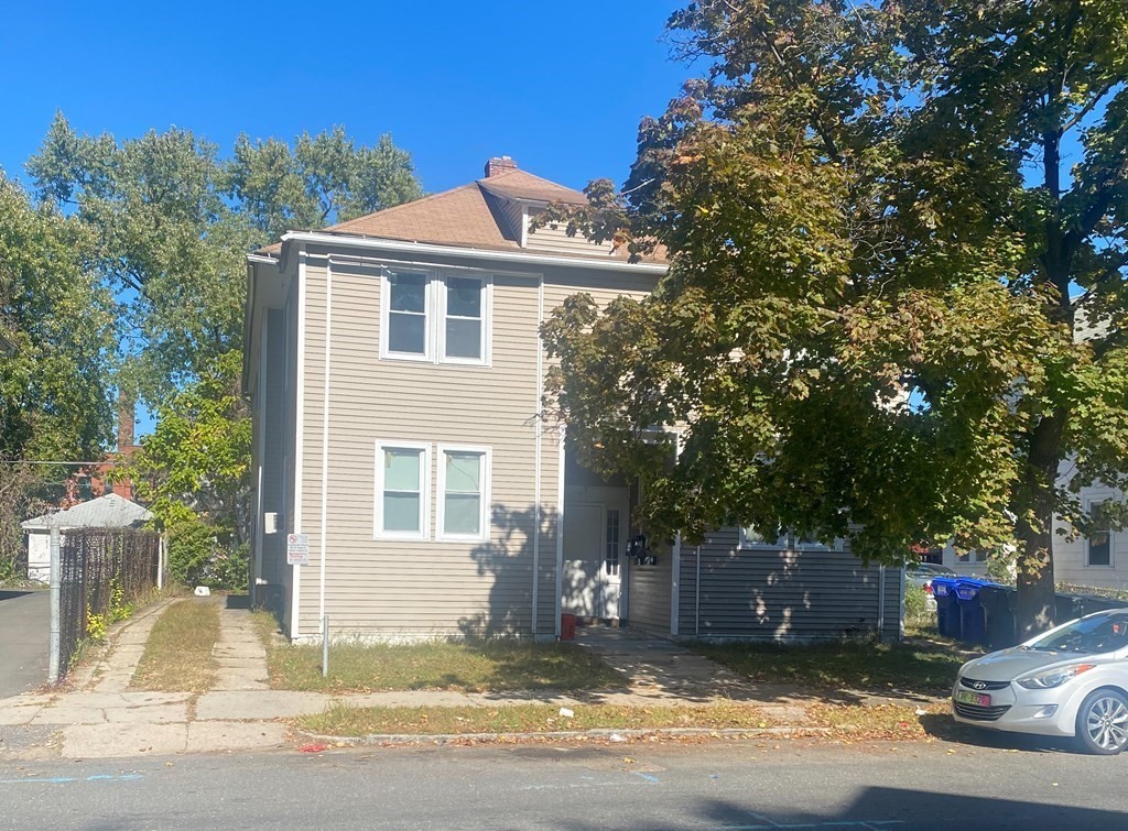 58 Johnson Street Springfield, MA 01108 - Photo 1 of 34 a view of a house with a yard and large tree