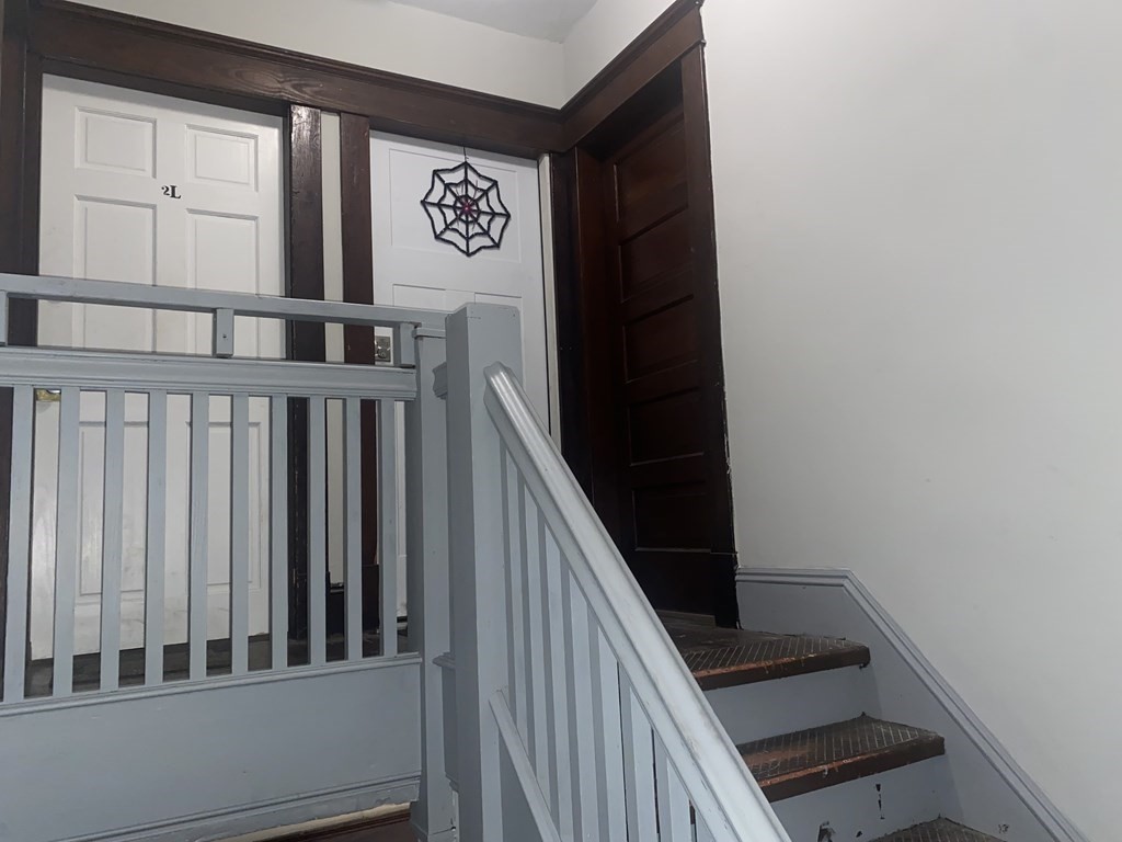 58 Johnson Street Springfield, MA 01108 - Photo 5 of 34 a view of a hallway with wooden floor and staircase