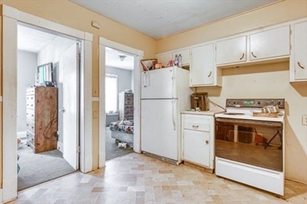 58 Johnson Street Springfield, MA 01108 - Photo 9 of 34 a kitchen with a stove and a refrigerator