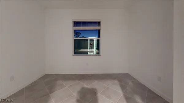 a view of a small space with wooden floor and a window