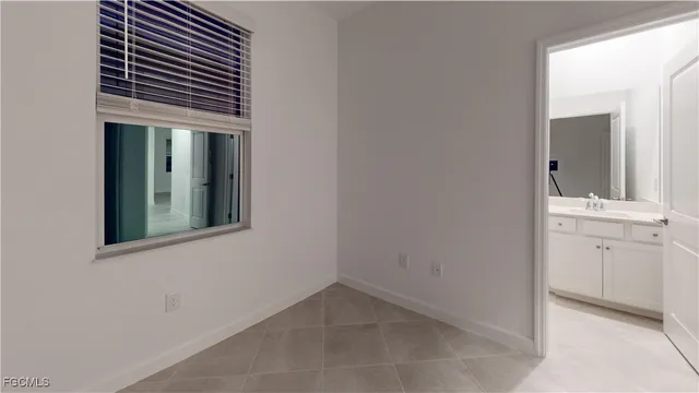 an entryway with wooden floor and cabinet