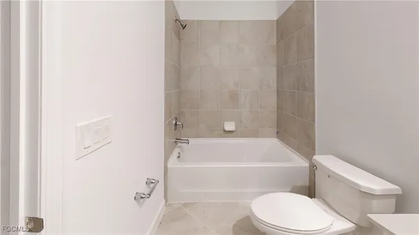 a bathroom with a toilet and a bath tub