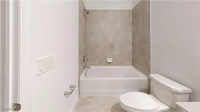 a bathroom with a toilet and a bath tub