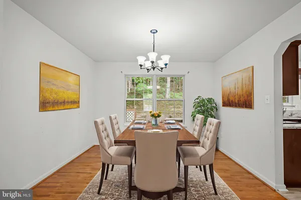 a dining room with furniture a window and a chandelier