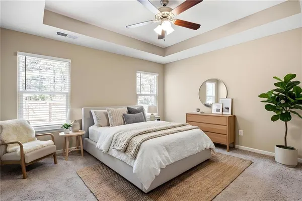 a bedroom with a large bed and windows