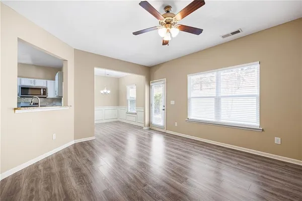 wooden floor in an empty room with a window