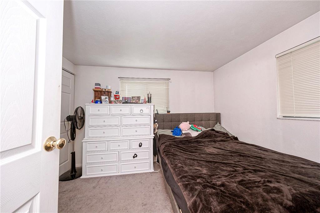 1023 Middle Road Glenshaw, PA 15116 - Photo 41 of 44 Generously sized primary bedroom in the suite, featuring neutral carpeting and peaceful views.