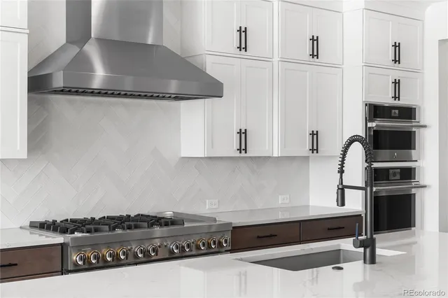 a kitchen with stainless steel appliances granite countertop a stove and a refrigerator