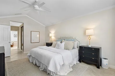 a bedroom with a bed and a lamp