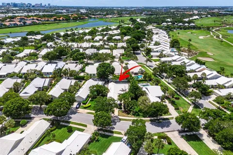 an aerial view of residential houses with outdoor space and trees