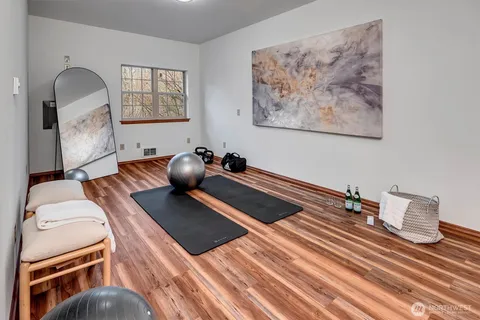 a bedroom with bed and wooden floor