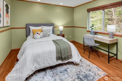 a bedroom with a bed a table and chair