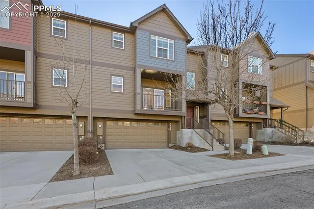 a view of a brick house with many windows