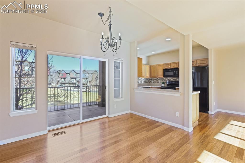 4058 Star View Colorado Springs, CO 80907 - Photo 13 of 41 a view of a kitchen with a sink and refrigerator wooden floor
